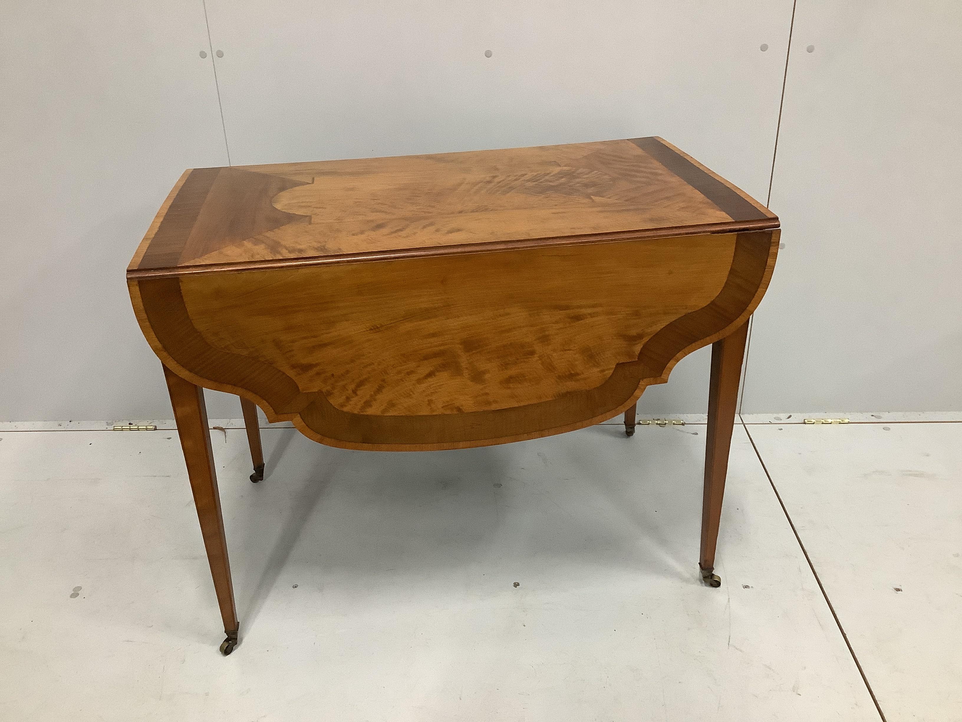 A reproduction Sheraton style sycamore banded satinwood Pembroke table, width 58cm, depth 96cm, height 73cm